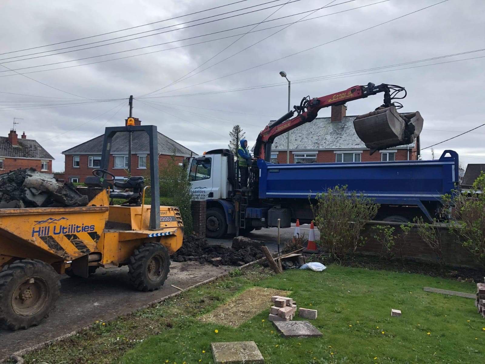 Excavated material being loaded out by dumper and grab lorry.