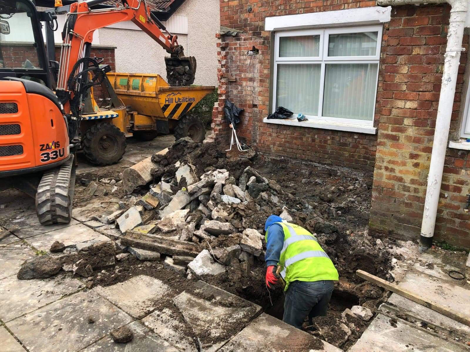 Excavation and muck-away under way for a new driveway.