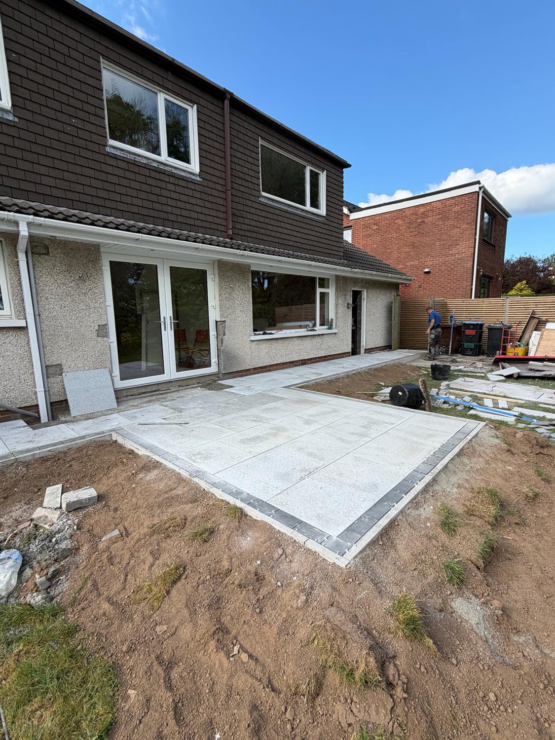A new porcelain patio and path with a contrasting dark border.