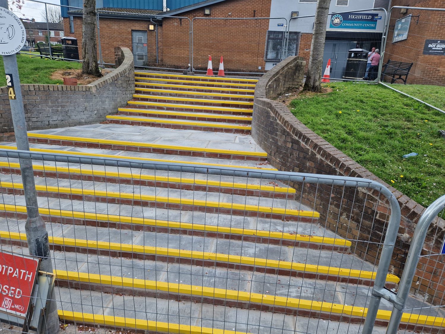 Rebuilt community-building steps with fresh treads and high-visibility nosings.
